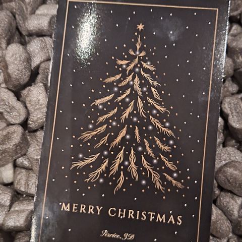 Weihnachtskarte mit Tannenmotiv in der Verpackung
